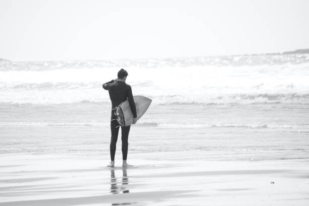Llangennith, Gower Peninsula, Swansea, Wales. With campsites and beach car parks open surfers flock to the beaches to surf the waves and enjoy the outdoor spaces offered on this beautiful coastline. Enough space for social distancing.