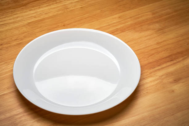 istock white empty cuisine tableware dish isolated on wooden dinner table in light and shade 1328153794