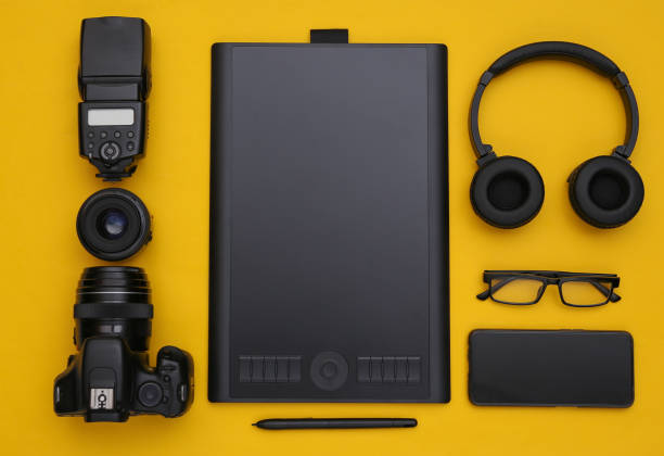 istock Photographer retouching equipment on a yellow background. Top view. Flat lay 1328156573