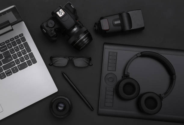 istock Photographer retouching equipment on black background. Top view. Flat lay 1328156596