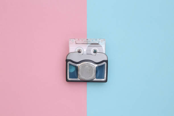 istock Mini audio player with audio cassette on a blue pink background. Top view 1328156609