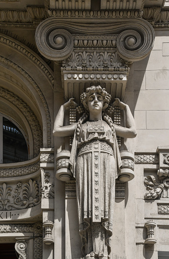 A caryatid is a sculpted female figure serving as an architectural support taking the place of a column or a pillar supporting an entablature on her head.