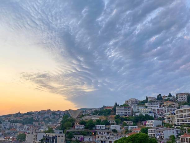 istock Sunset clouds heaven over old town. Romantic evening twilight by Mediterranean coast. Impressive sky dusk. Spectacular cloudscape. Old city Ulcinj in Montenegro. 1328159313