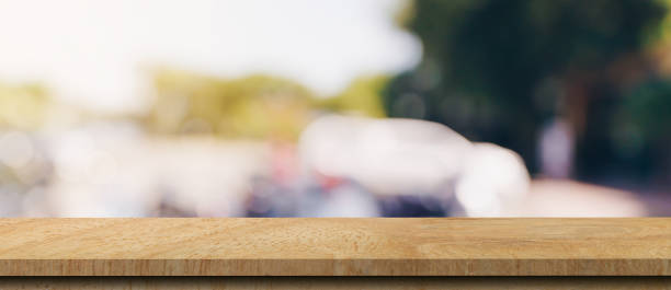 istock Empty wood table and blurred light table in coffee shop and cafe with bokeh background. product display template. 1328165886