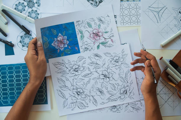 Designer designing drawing sketch pattern geometric flower seamless wallpaper fabric textile fashion industry. artistic design studio.