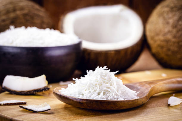 grated coconut wooden spoon, coconut-based ingredient grated coconut wooden spoon, coconut-based ingredient cocos stock pictures, royalty-free photos & images