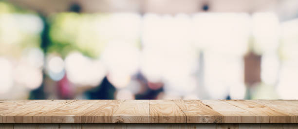 istock Empty wood table and blurred light table in coffee shop and cafe with bokeh background. product display template. 1328170002
