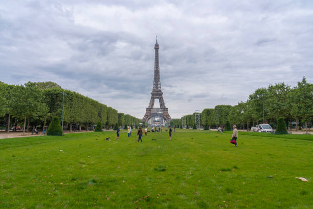 Paris : Eiffel Tower and Champ de Mars are empty during pandemic Covid 19 in Europe. There are no people, no cars, no tourists because people must stay at home and be confine. Schools, restaurants, stores, museums... are closed. In the foreground, there is the \