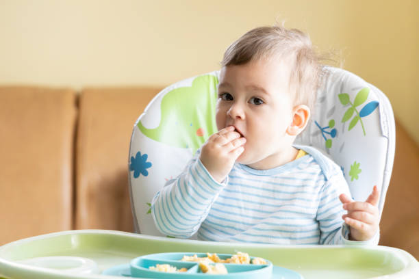 istock little cute baby eating breakfast 1328174564