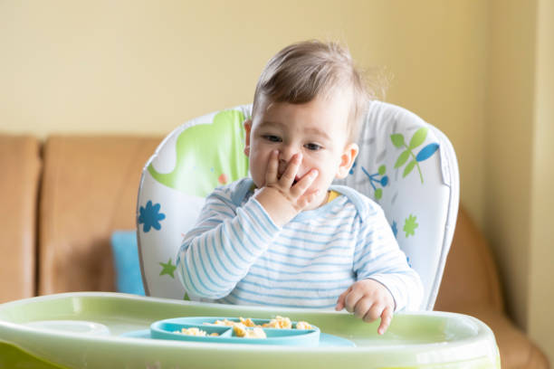istock little cute baby eating breakfast 1328174579