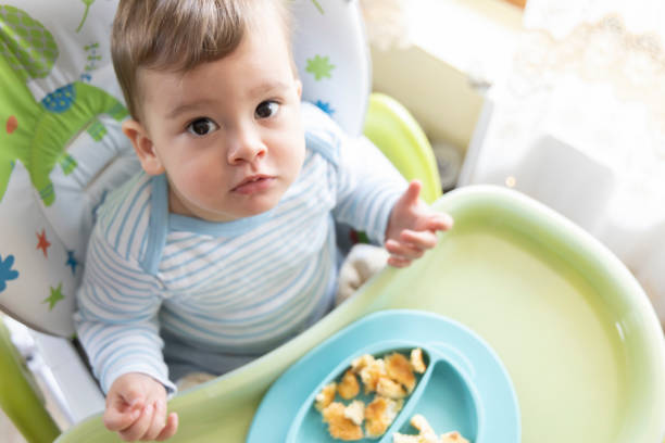 istock little cute baby eating breakfast 1328174598