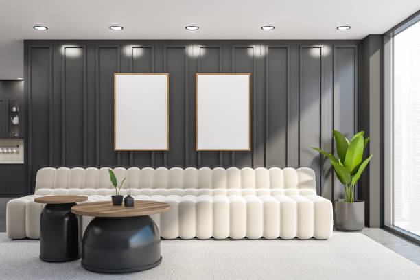 istock Gray office waiting room interior with sofa and two vertical posters 1328175437
