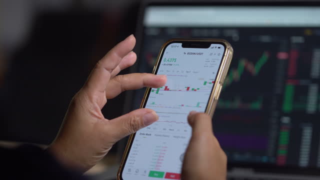 Investor checking cryptocurrency price index on mobile phone screen, cryptocurrency future price action prediction concept