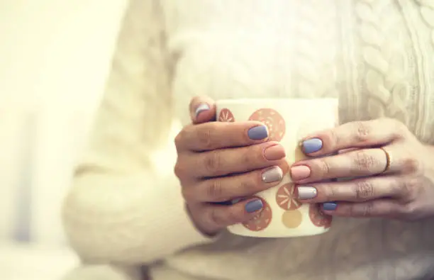 Manicure - Beauty treatment photo of nice manicured woman fingernails. Very nice feminine nail art with nice pink and purple nail polish. Processed in retro colors.