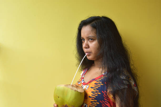 Pregnant women drink coconut water to nourish the skin of the fetus and for their health. Pregnant women drink coconut water to nourish the skin of the fetus and for their health. nourish stock pictures, royalty-free photos & images