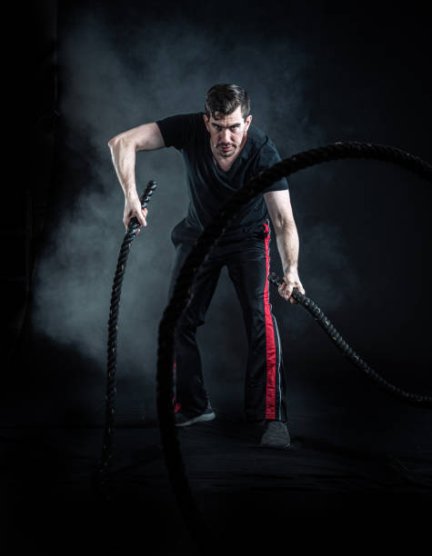 istock Hispanic Athlete cross training with battle ropes 1328181335