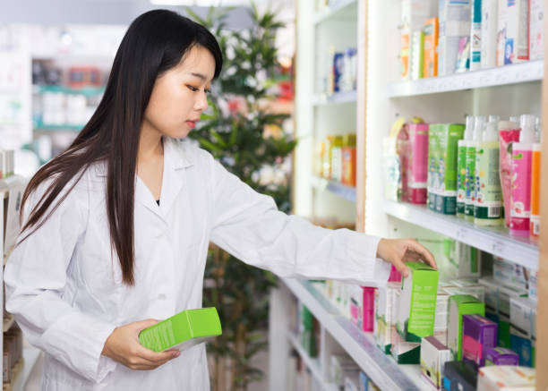istock Chinese female pharmacist standing in pharmacy 1328184693