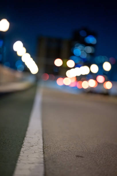 istock City at night focus on white road line 1328187725