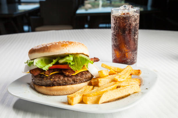 istock Delicious hamburger with vegetables on wooden board 1328189121