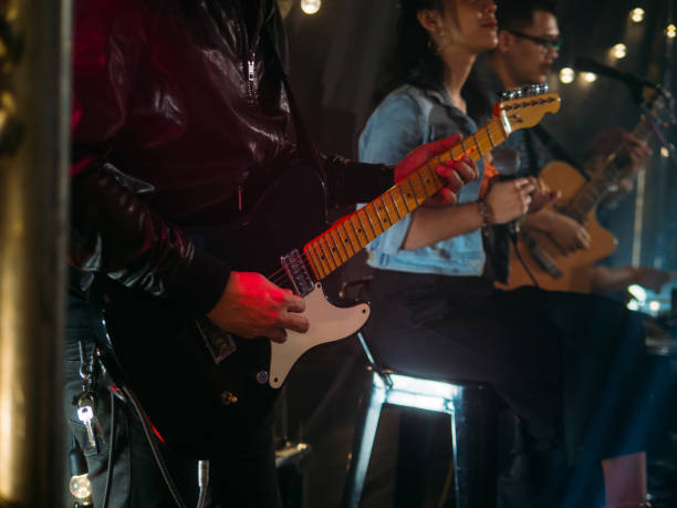 istock Music band performing on stage in night club 1328190147