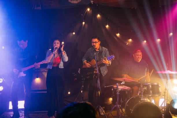 istock Music band performing on stage in night club 1328190197