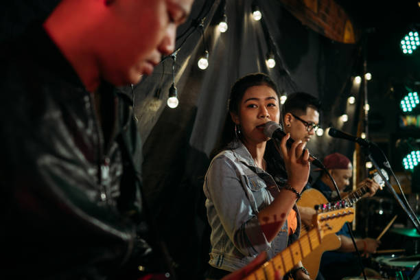 istock Music band performing on stage in night club 1328190245