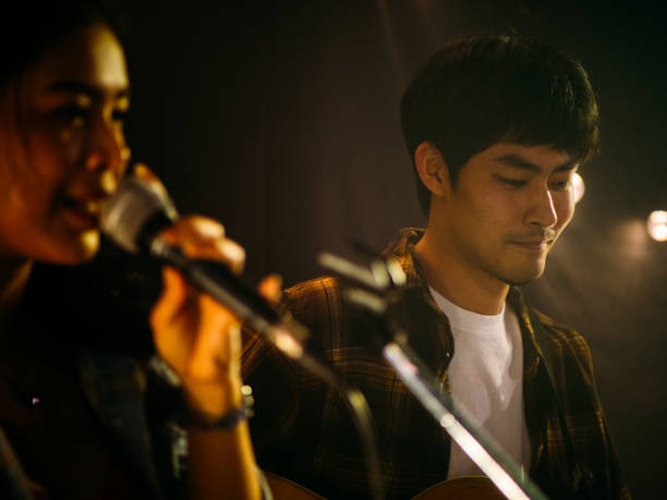 istock Young couple performing the music on the stage. 1328190318