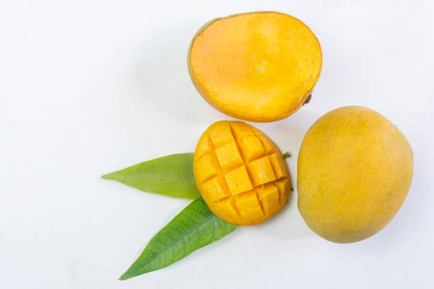 istock Fresh ripe mango tropical fruit with green leaf on white isolated background. 1328190325