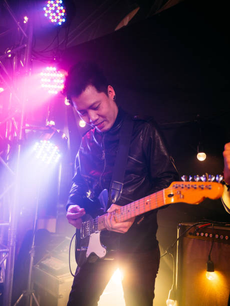 istock Music band performing on stage in night club 1328190436