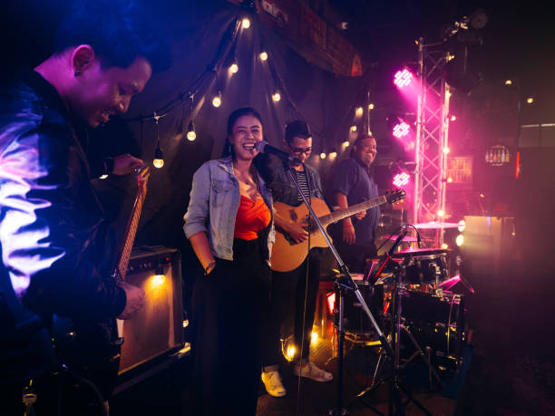 istock Music band performing on stage in night club 1328190462
