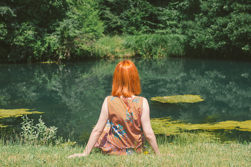 Attractive Redhead Woman in the River
