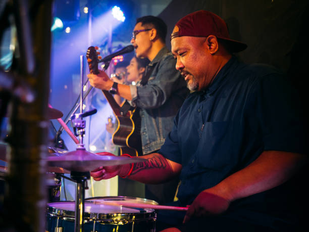 istock Music band performing on stage in night club 1328190520