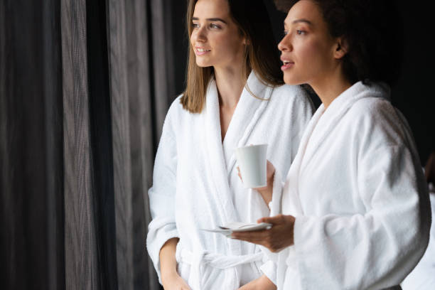 istock Attractive happy young women drinking coffee at spa center 1328191898