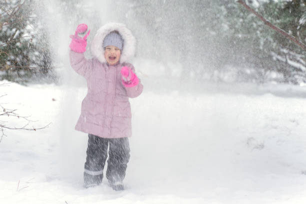 istock a child is covered with snow in a severe blizzard 1328192261