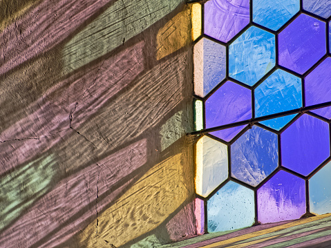 Close up image of window featuring beveled and textured glass distorting the view.