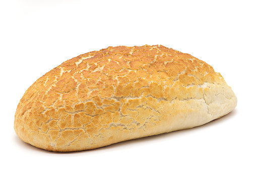 One unsliced Tiger Bread Loaf lying on a white base and on a white back ground. A good image for a Baker or delicatessen.