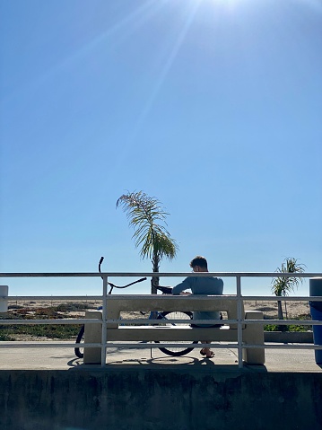 Newport Beach, USA - January 10, 2020: Man relaxing on the beach