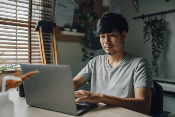 istock Worried man working at home. 1328200689