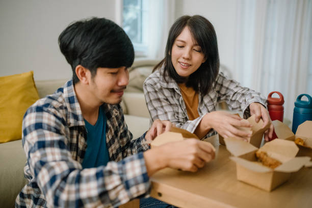 istock Asian couple having lunch at home during quarantine. 1328201462