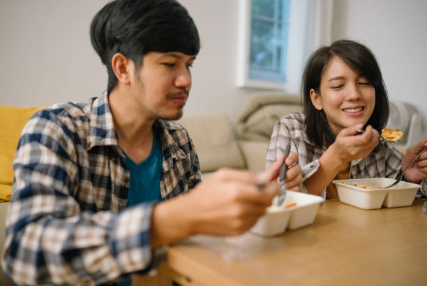 istock Asian couple having lunch at home during quarantine. 1328201554