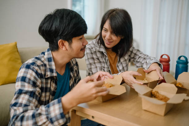 istock Asian couple having lunch at home during quarantine. 1328201578