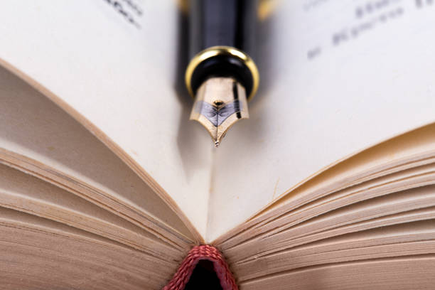 istock Open book and fountain pen 1328203140