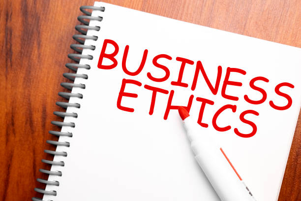 istock Text BUSINESS ETHICS written in notepad, Office wood table and red marker from above, concept image for blog title or header image. Aged vintage color look. 1328205840