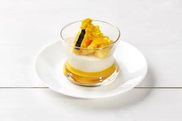 Photo of Creamy Panna cotta with mango and vanilla in glass