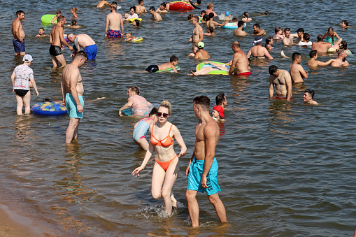 Moscow, Russia - July 2021: People swimming in Moscow river in Strogino district