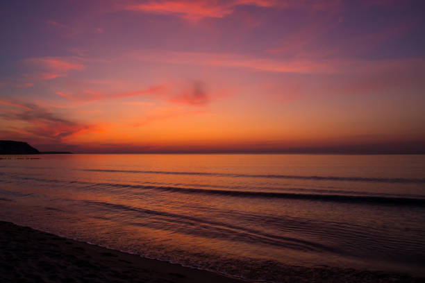 istock beautiful sunset on the sea. beach and surf at sunset. 1328210295