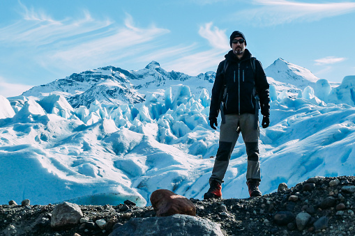 Tourist looking at camera posing on the Perito Moreno Glacier, Argentina. Concept of tourism.