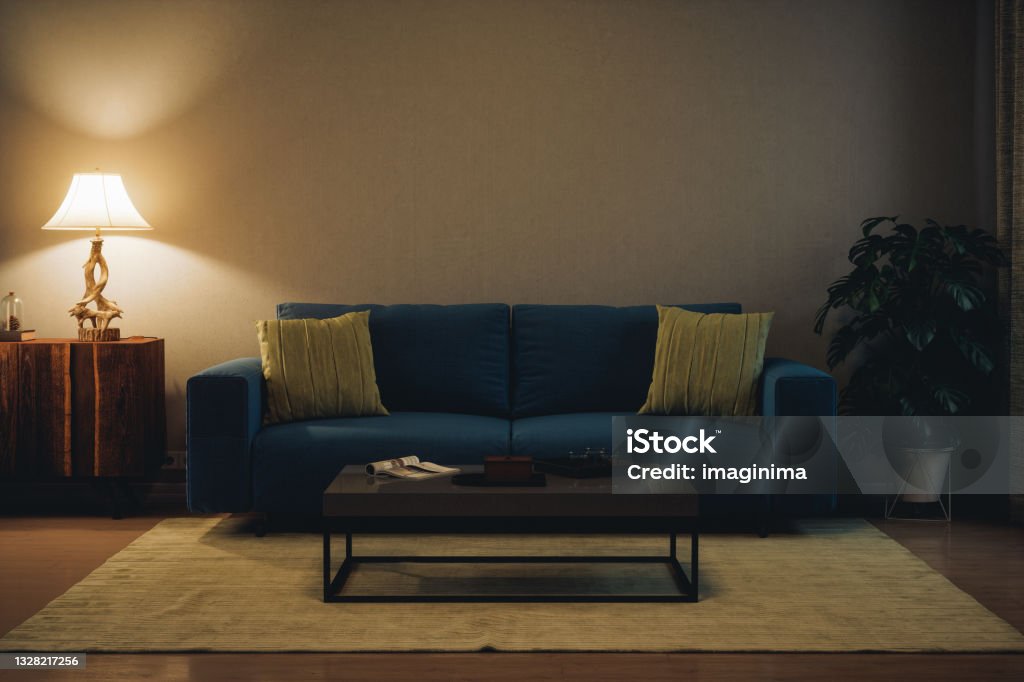Modern Living Room At Night Living room with modern furniture, illuminated by table lamp. Living Room Stock Photo