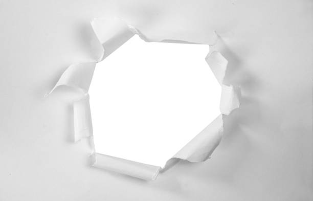 istock Hole in a Torn Paper over White Background 1328219629