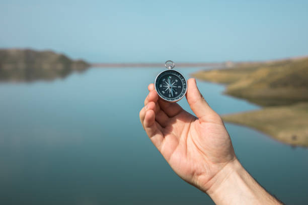 istock man holding compass in lake background 1328219929